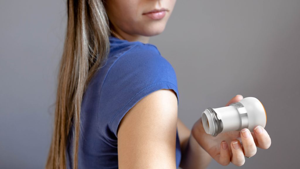 A person holding a transdermal patch applicator