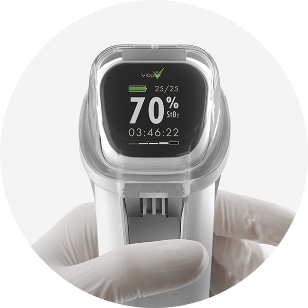 A gloved hand holds the ViOptix Intra.Ox, a sleek white medical device displaying a 70% SPO2 level and a countdown timer.